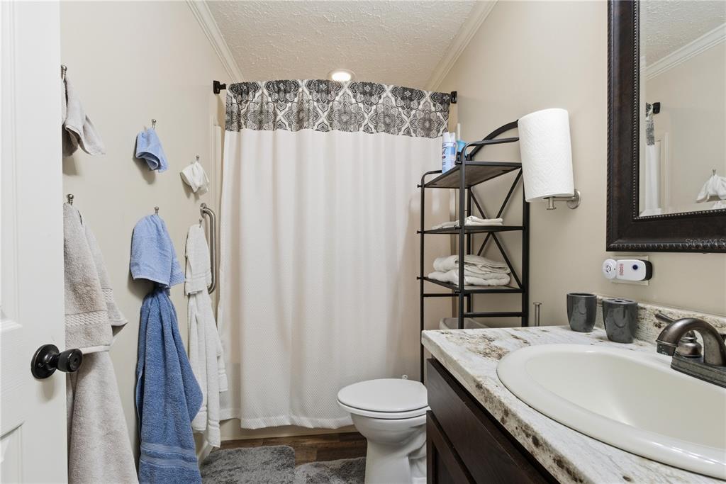 7970 Southwest 14th Place Bell, FL 32619 - Photo 31 of 45 a bathroom with a sink toilet and shower