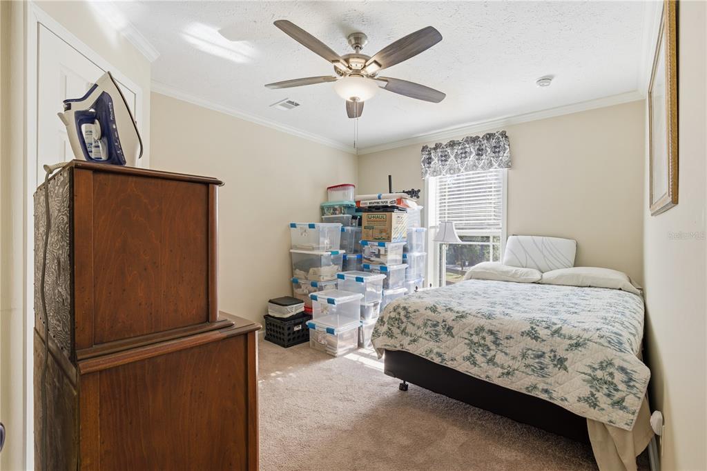 7970 Southwest 14th Place Bell, FL 32619 - Photo 32 of 45 a bedroom with a bed and ceiling fan