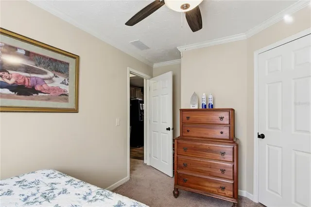 a bedroom with a bed and ceiling fan
