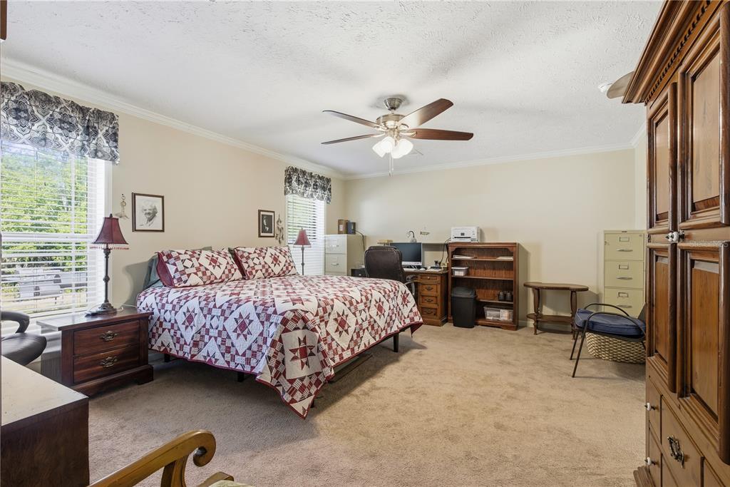 7970 Southwest 14th Place Bell, FL 32619 - Photo 34 of 45 a bedroom with a bed furniture and a ceiling fan