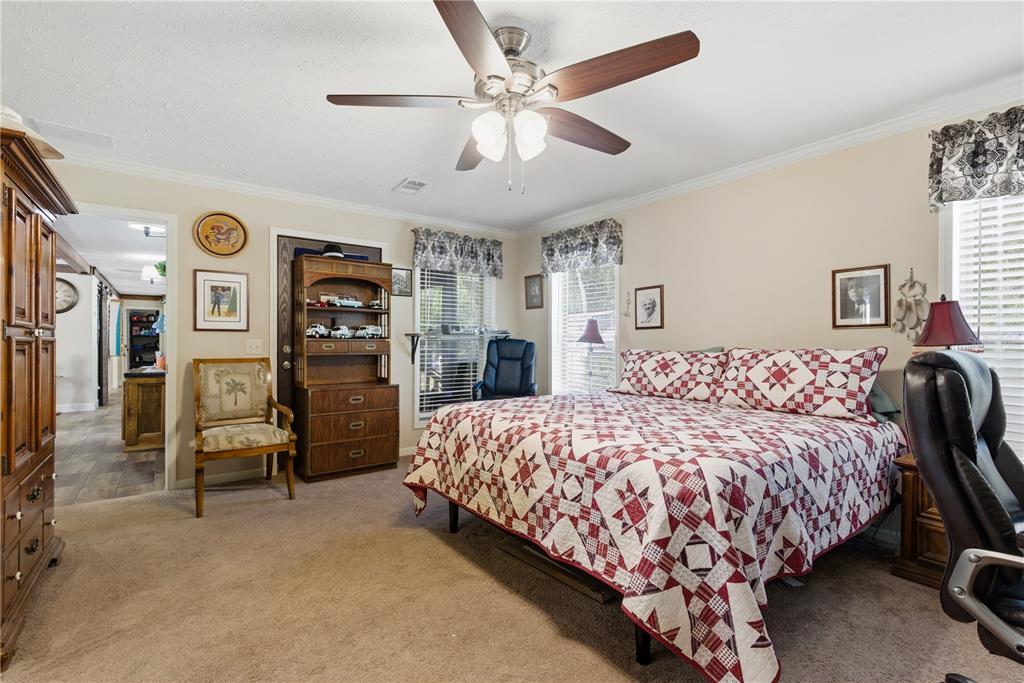 7970 Southwest 14th Place Bell, FL 32619 - Photo 35 of 45 a bedroom with a bed and ceiling fan