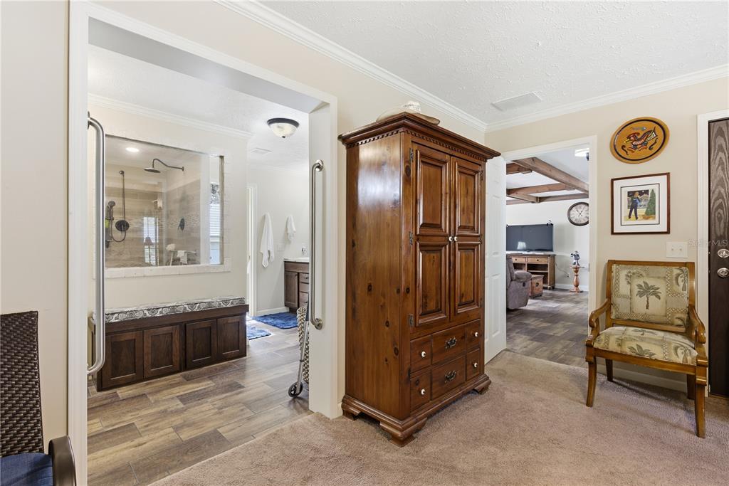 7970 Southwest 14th Place Bell, FL 32619 - Photo 38 of 45 a spacious bedroom with a bed and a mirror