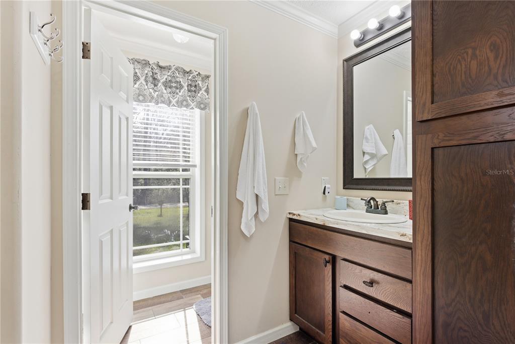 7970 Southwest 14th Place Bell, FL 32619 - Photo 41 of 45 a bathroom with a double vanity sink mirror and