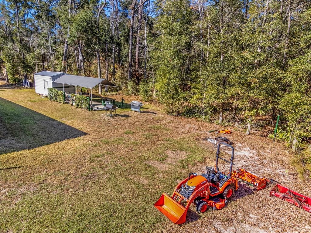 7970 Southwest 14th Place Bell, FL 32619 - Photo 9 of 45 a backyard of a house with table and chairs