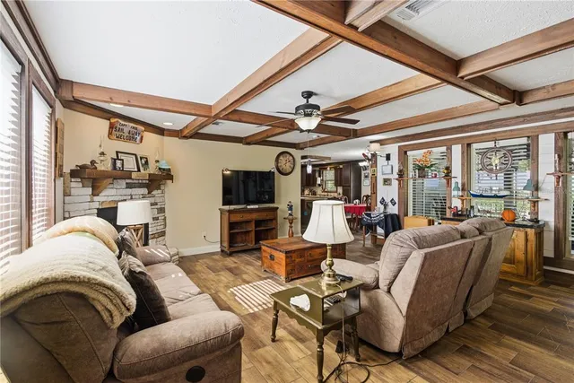 a living room with furniture fireplace and flat screen tv
