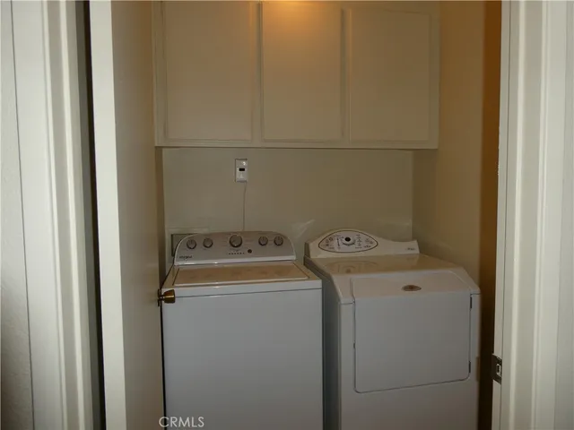 a view of a house with a yard and large tree