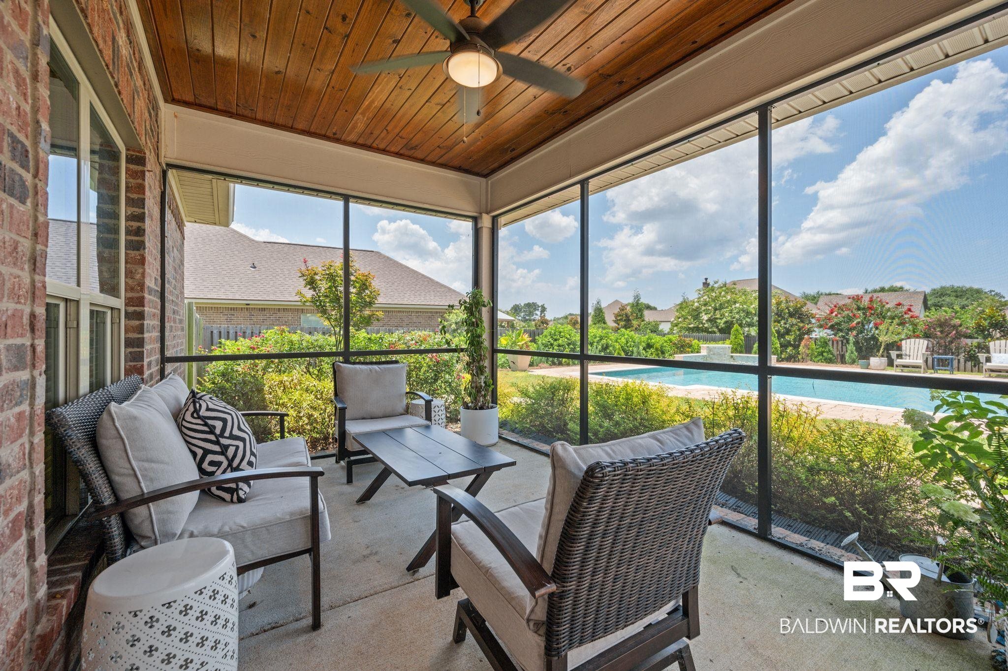 409 Fortune Drive Fairhope, AL 36532 - Photo 35 of 42 Screened patio featuring a wood-panel ceiling, ceiling fan, and brick exterior wall