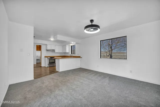 a bathroom with a granite countertop sink mirror and toilet