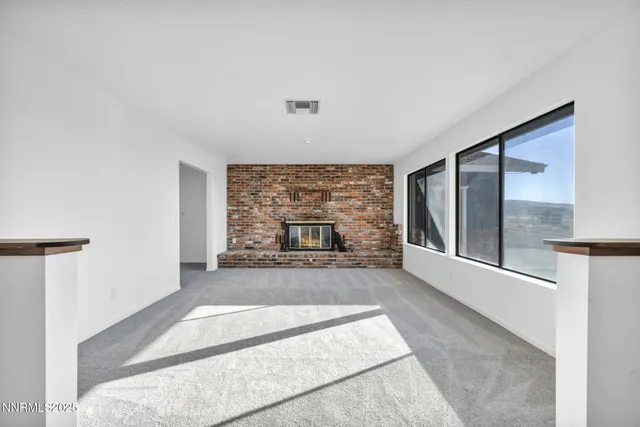 an empty room with a ceiling fan and a window