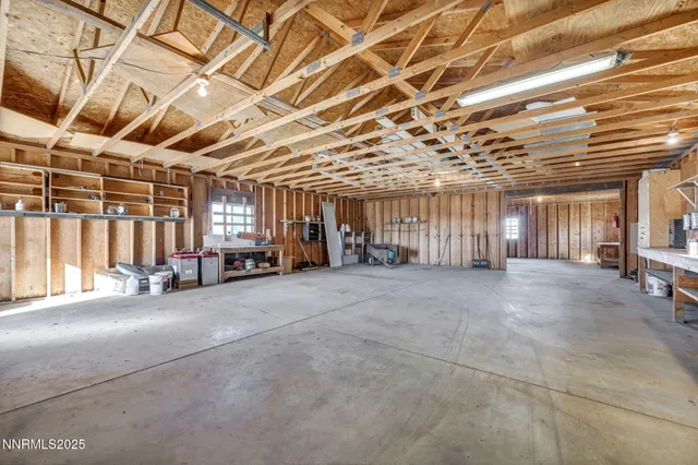 a view of hallway with window and wooden floor