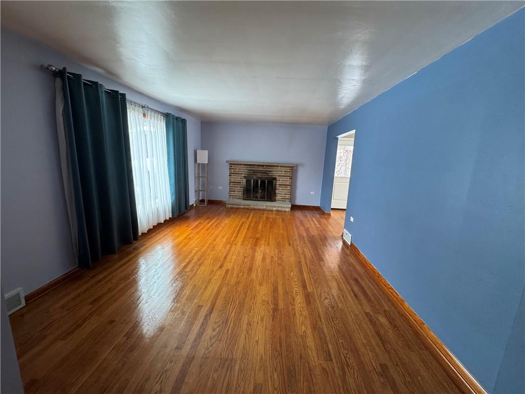 113 Greenhill Drive Butler, PA 16001 - Photo 2 of 19 wooden floor in an empty room with a window