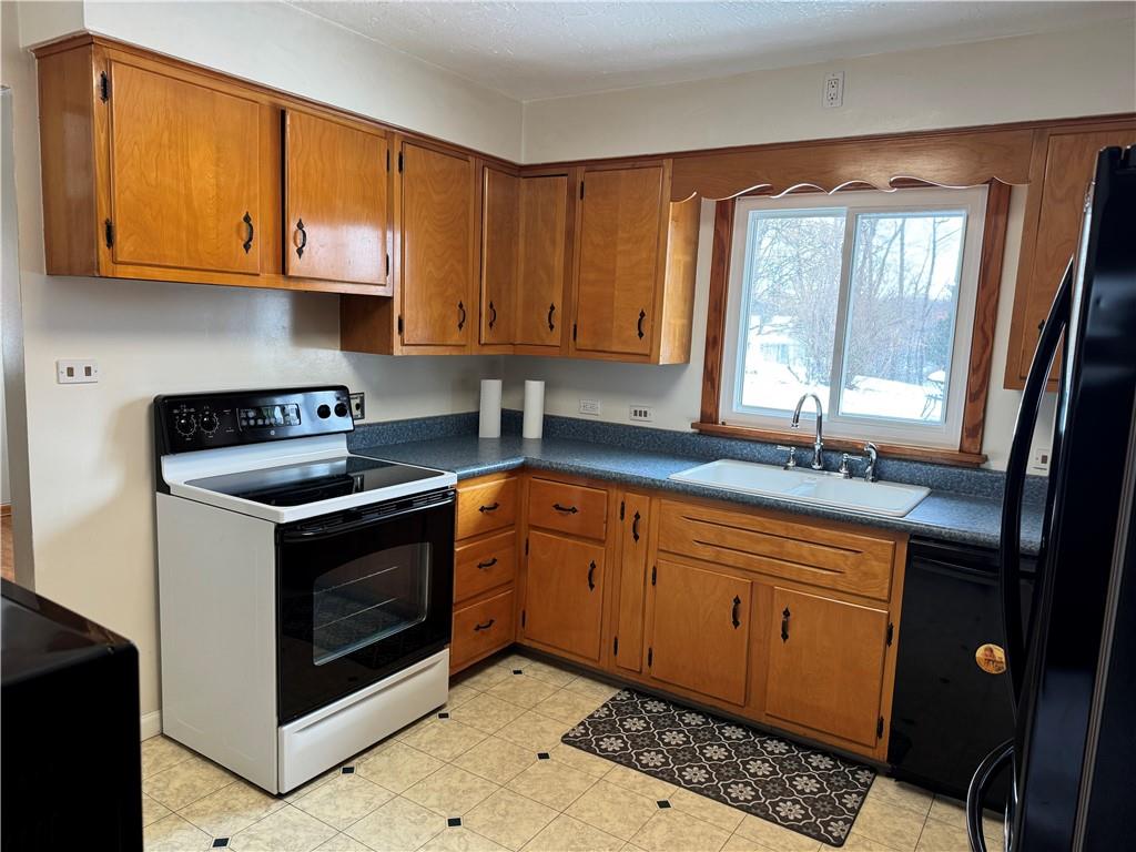 113 Greenhill Drive Butler, PA 16001 - Photo 5 of 19 a kitchen with stainless steel appliances granite countertop a sink stove and cabinets