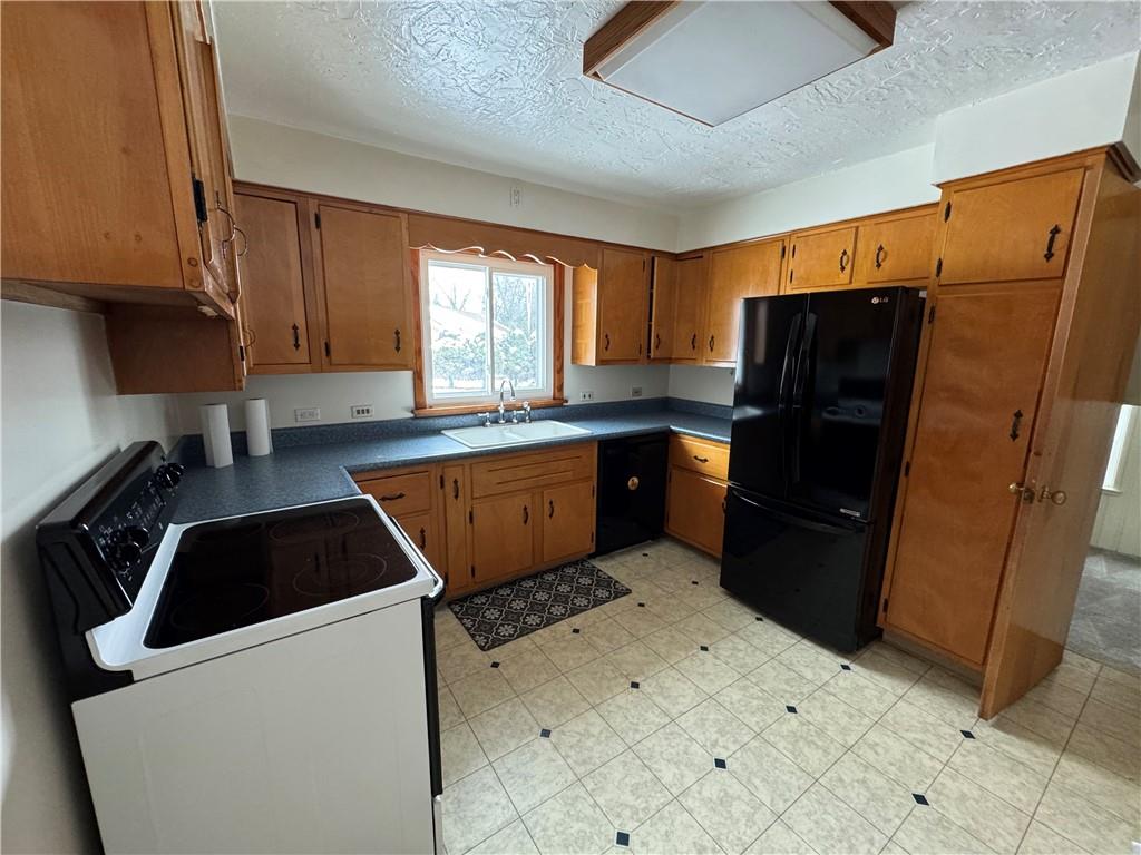 113 Greenhill Drive Butler, PA 16001 - Photo 6 of 19 a kitchen with a sink a refrigerator and window