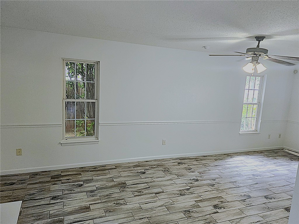 328 Springfield Circle Easley, SC 29642 - Photo 13 of 29 A well-lit living area features distinctive wood-look tile flooring and a refreshing ceiling fan.