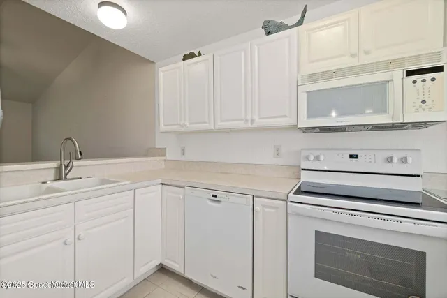 a kitchen with a refrigerator and a sink