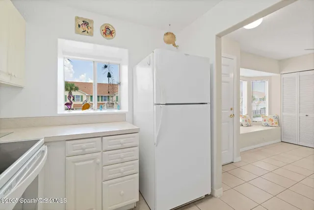 an empty room with a fan & a window