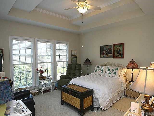 120 Challenge Raleigh, NC 27603 - Photo 6 of 9 a spacious bedroom with a bed a table and chair