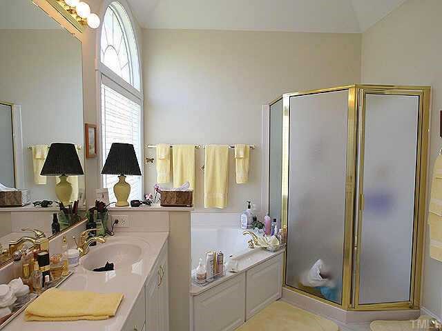 120 Challenge Raleigh, NC 27603 - Photo 7 of 9 a bathroom with a tub sink and mirror