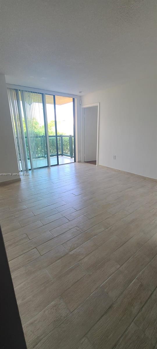 11800 Southwest 18th Street, Unit 4094 Miami, FL 33175 - Photo 8 of 14 an empty room with wooden floor and windows