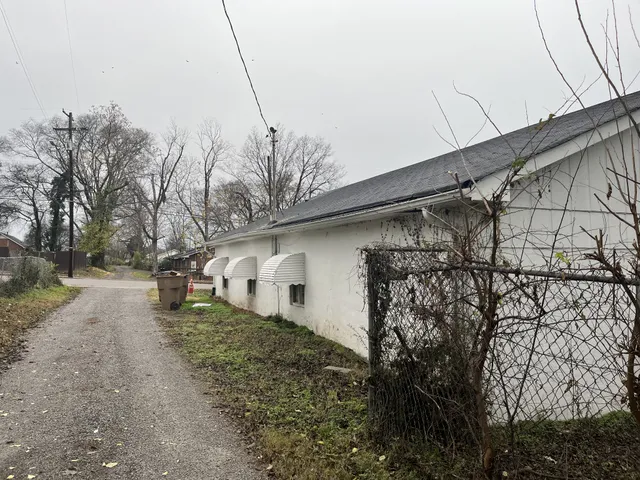 a view of a backyard with table and chairs under an umbrella