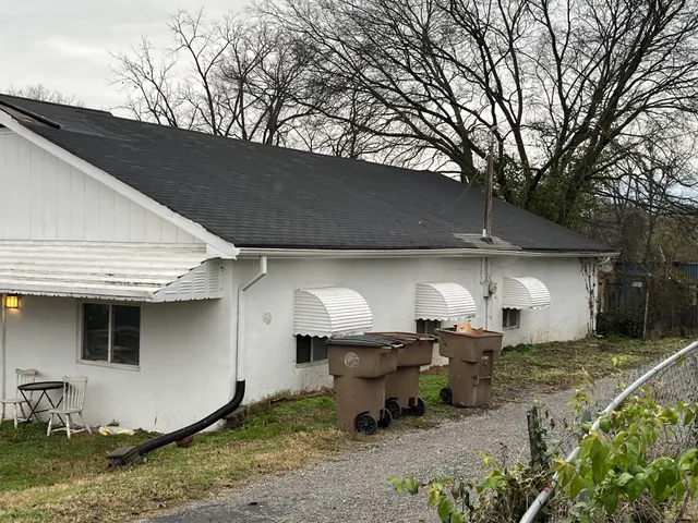 a view of a wooden house with a yard