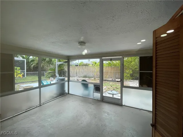 a large space with a large window and the kitchen view