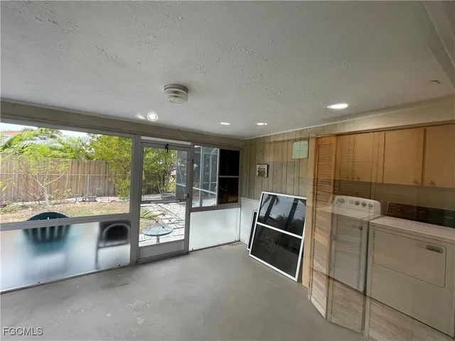 a living room with furniture a fireplace and a large window