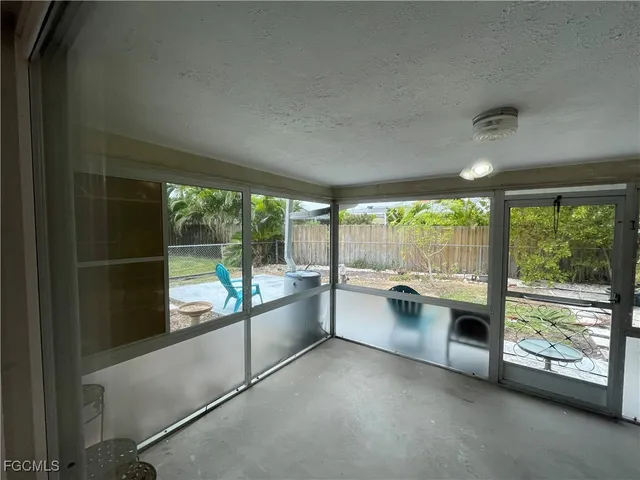 a kitchen with a large window and view of kitchen