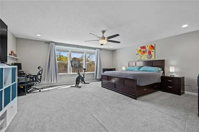 a spacious bedroom with a bed and a large window