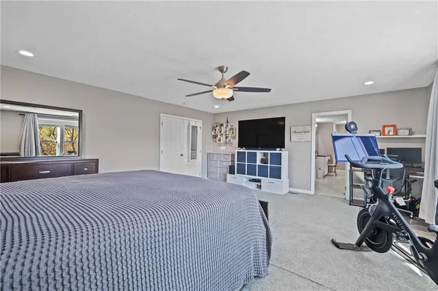 a bedroom with furniture a bed and a flat screen tv