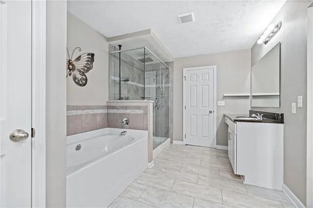 a bathroom with a bathtub a toilet and a shower