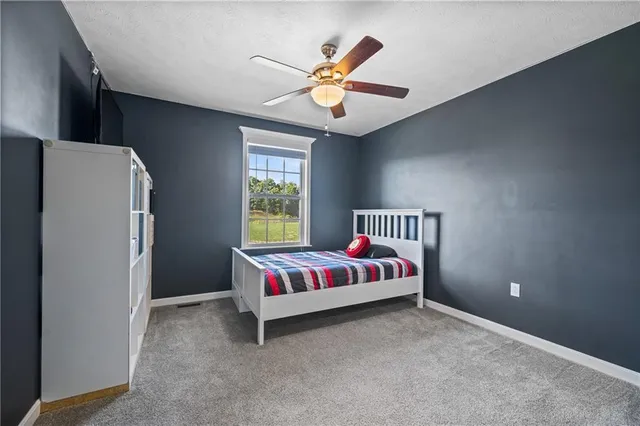 a workspace with a ceiling fan and a window