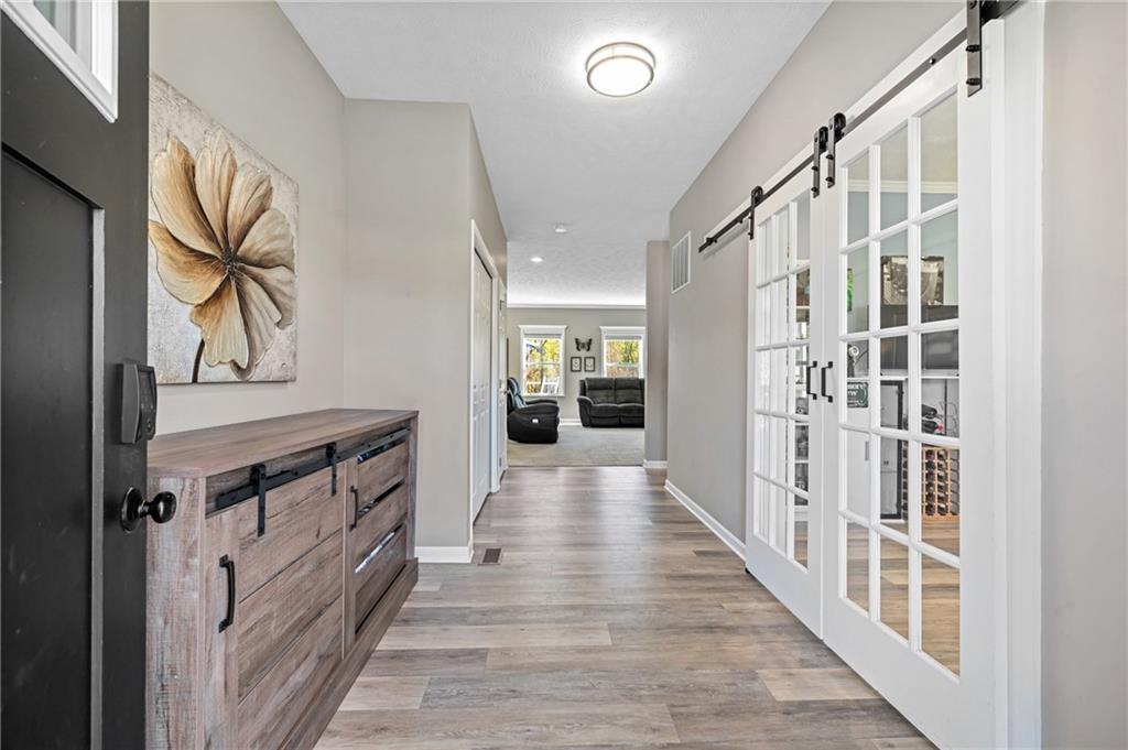 43 Trotter Lane Clinton, PA 15026 - Photo 2 of 34 a view of a hallway with wooden floor and staircase