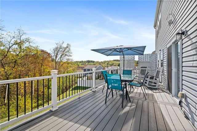 a view of a deck with furniture and wooden floor
