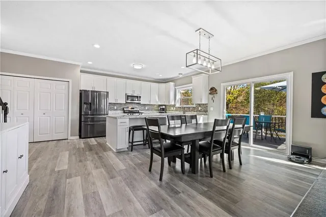 a view of a dining room with furniture window and wooden floor