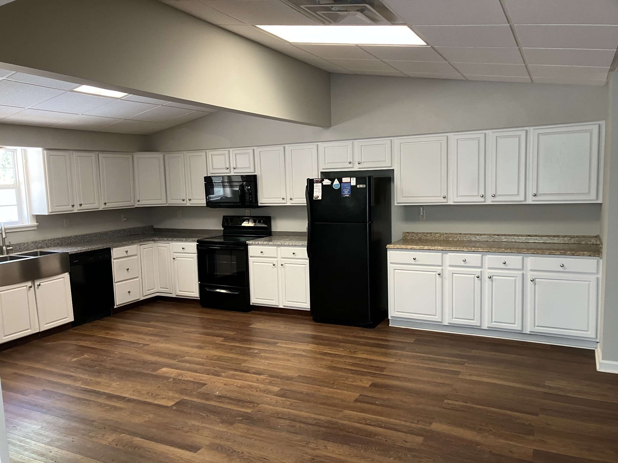 255 S Road Cottontown, TN 37048 - Photo 11 of 35 a kitchen with granite countertop a refrigerator stove top oven and cabinets