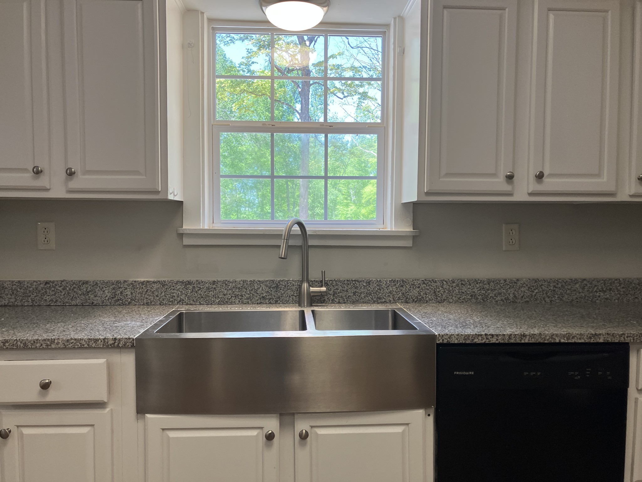 255 S Road Cottontown, TN 37048 - Photo 12 of 35 a kitchen with granite countertop a sink and a window