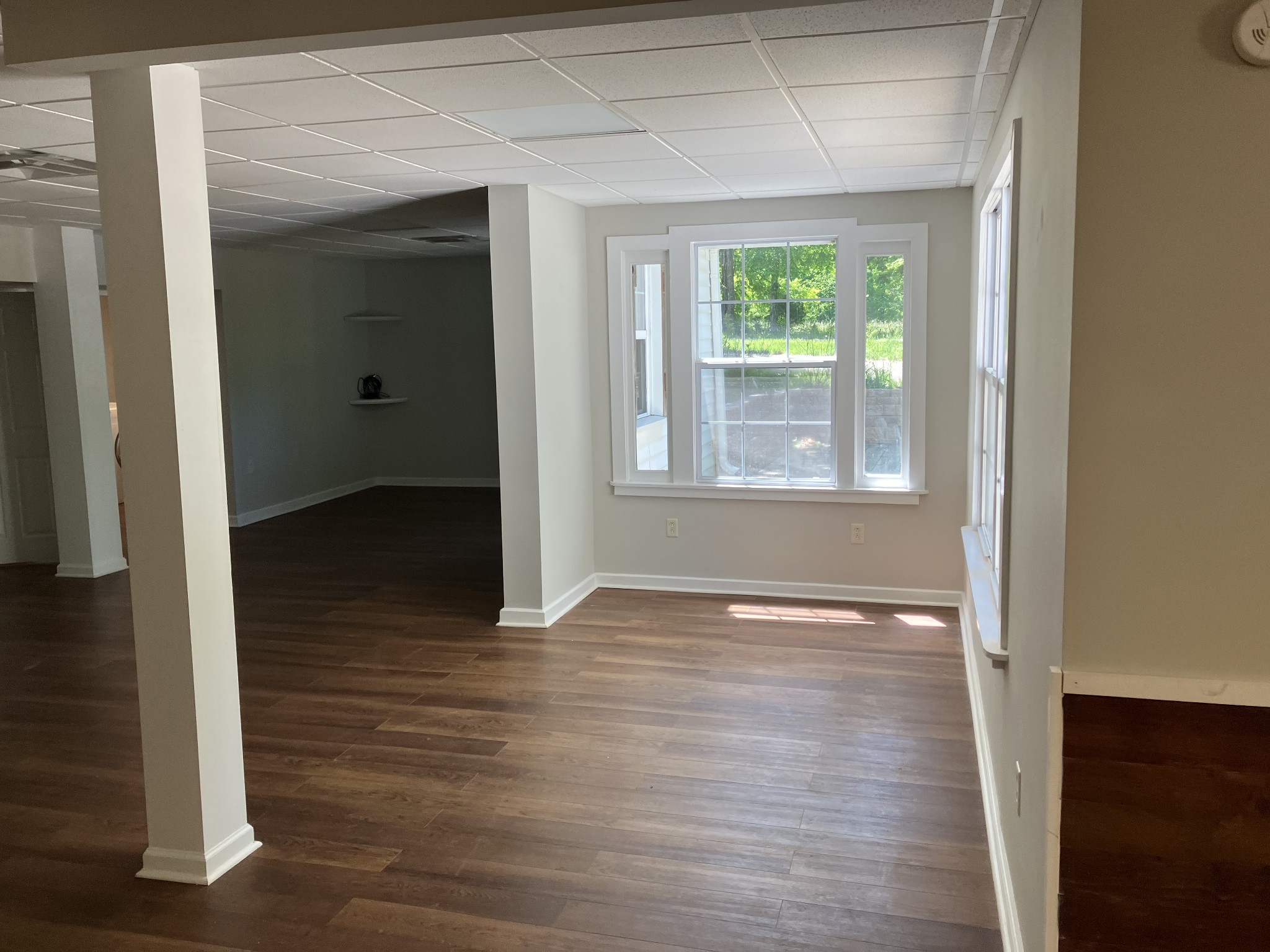 255 S Road Cottontown, TN 37048 - Photo 15 of 35 a view of an empty room with wooden floor and a window
