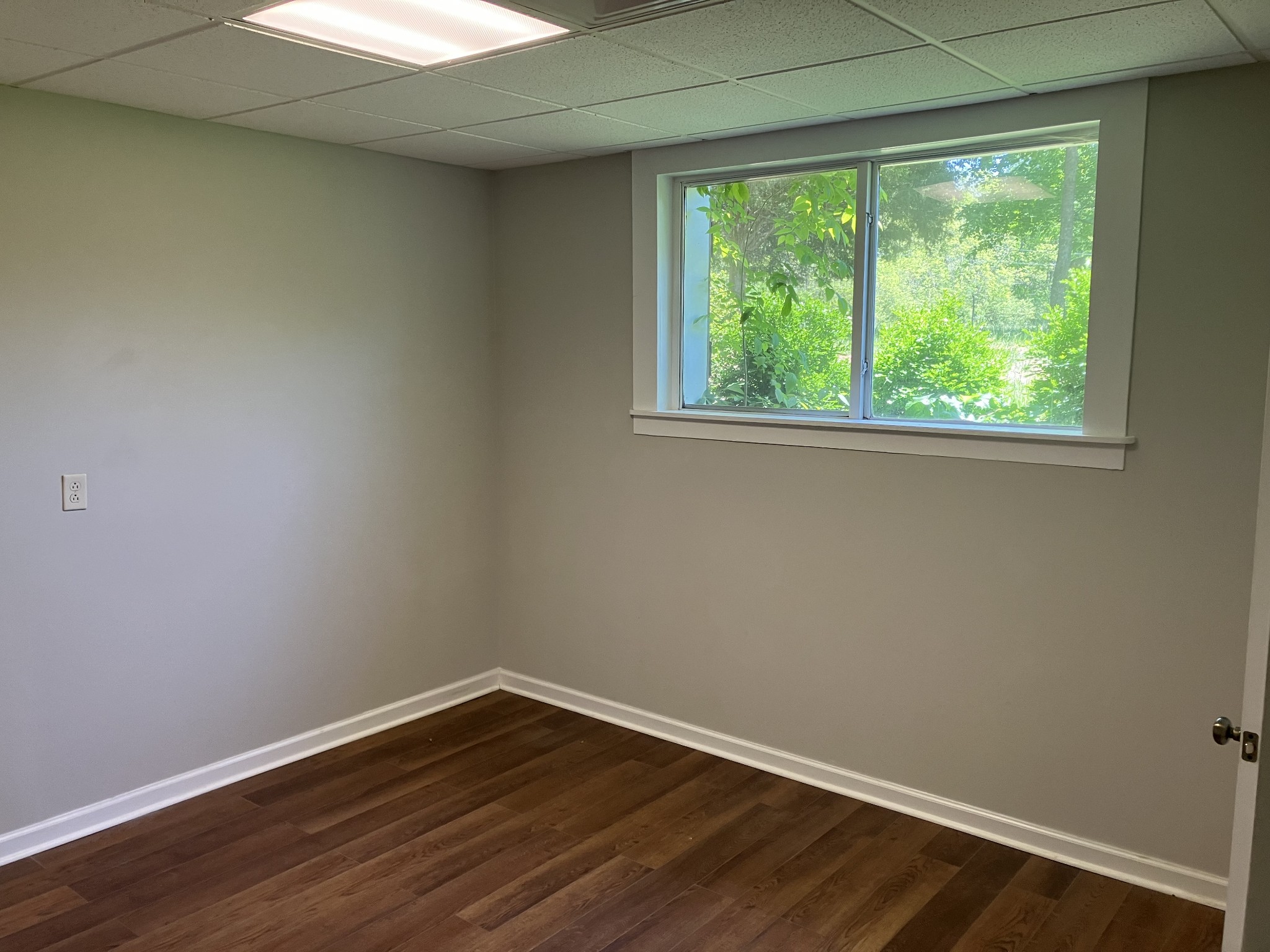 255 S Road Cottontown, TN 37048 - Photo 18 of 35 a view of an empty room with wooden floor and a window