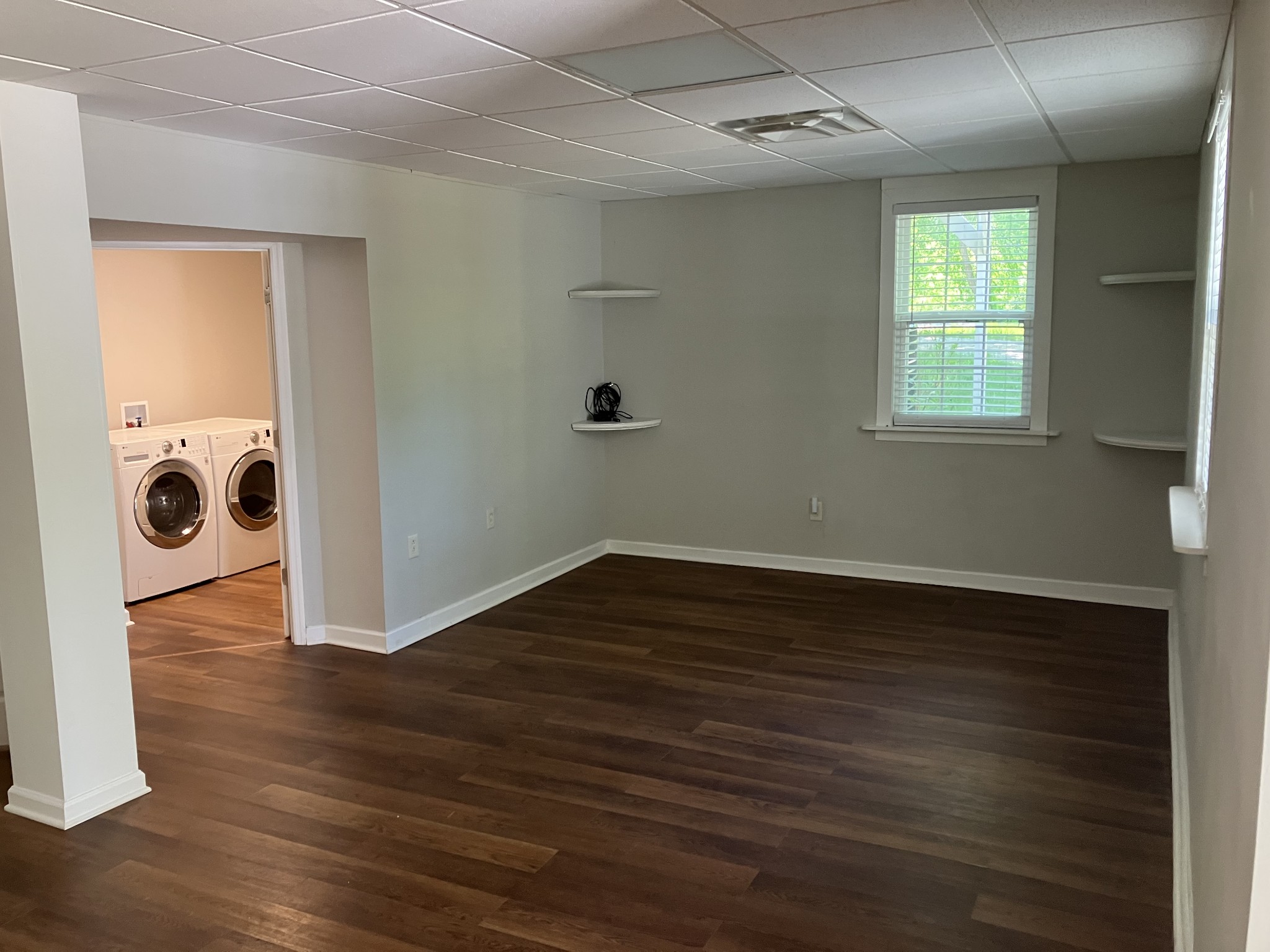 255 S Road Cottontown, TN 37048 - Photo 21 of 35 an empty room with wooden floor cabinet and windows