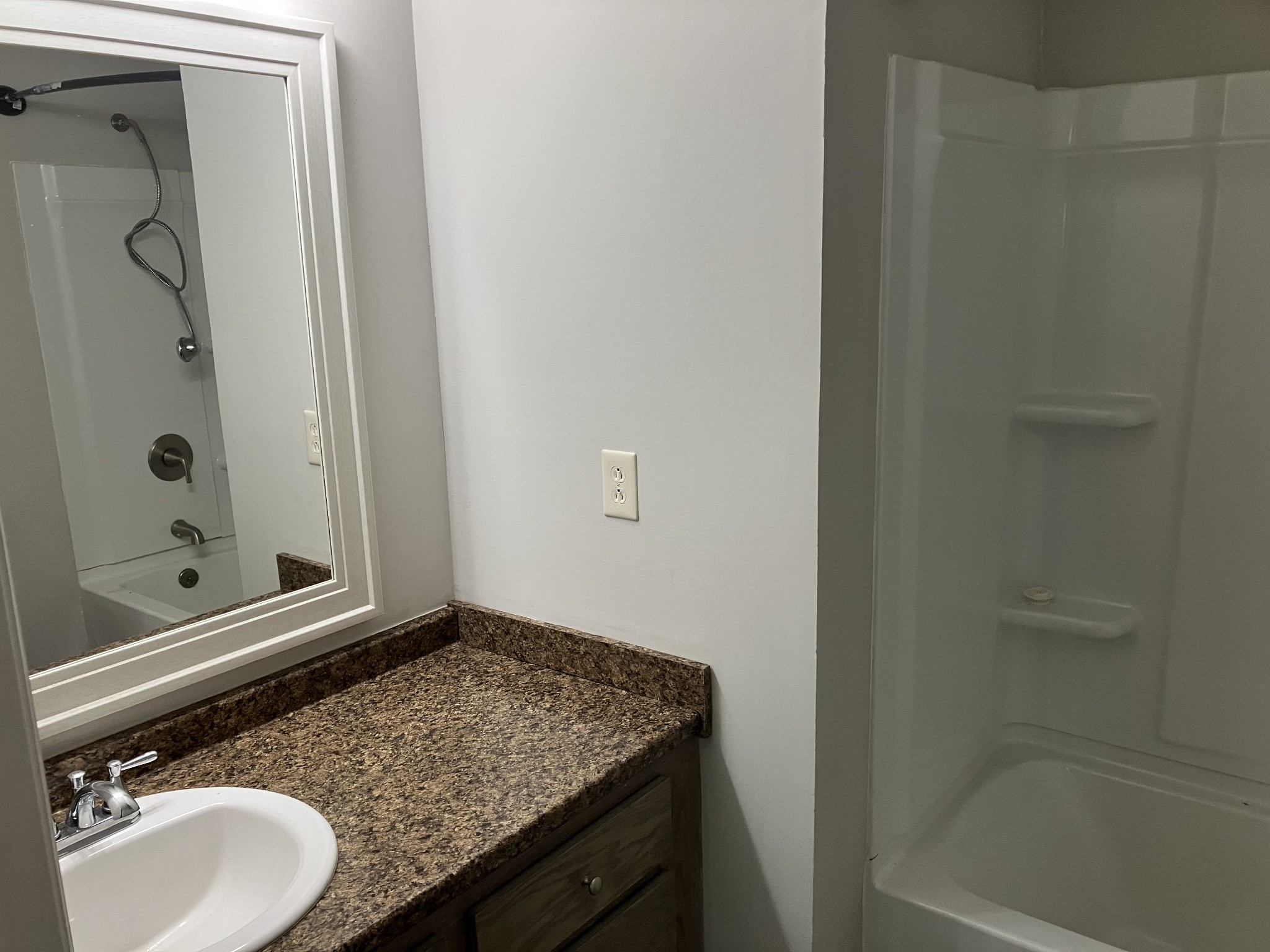 255 S Road Cottontown, TN 37048 - Photo 23 of 35 a bathroom with a granite countertop sink a mirror and shower