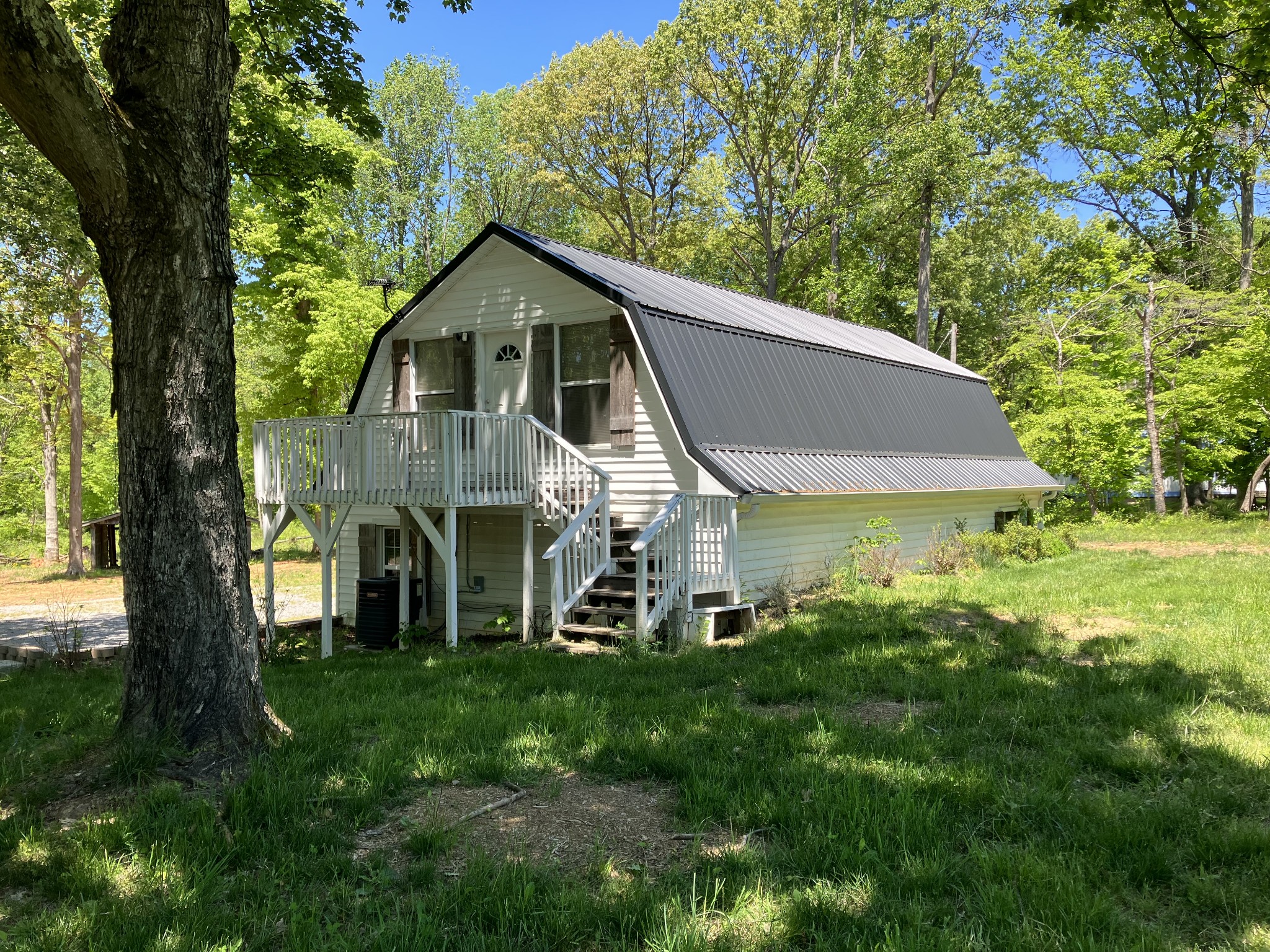 255 S Road Cottontown, TN 37048 - Photo 7 of 35 a front view of a house with a yard and porch