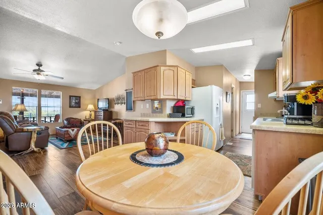 a dining room with furniture a window and wooden floor
