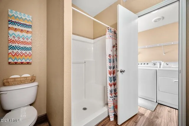 a bathroom with a toilet and a shower curtain