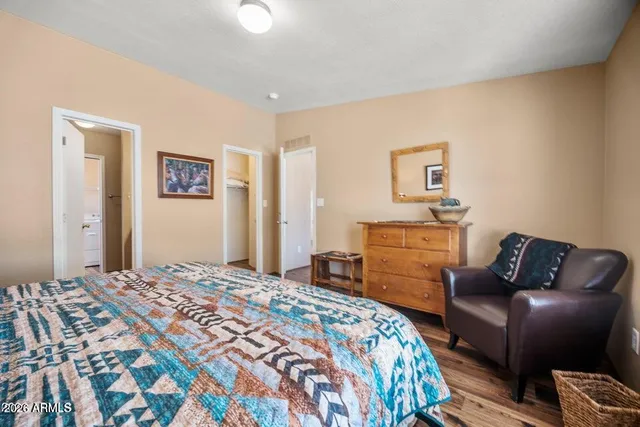 a bedroom with a bed and dresser