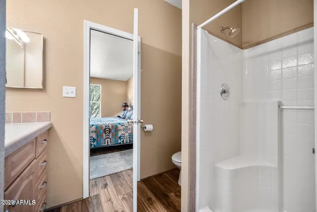 a en suite bathroom with a sink a toilet and shower