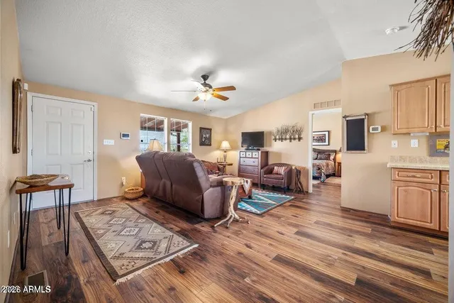 a living room with furniture and a wooden floor