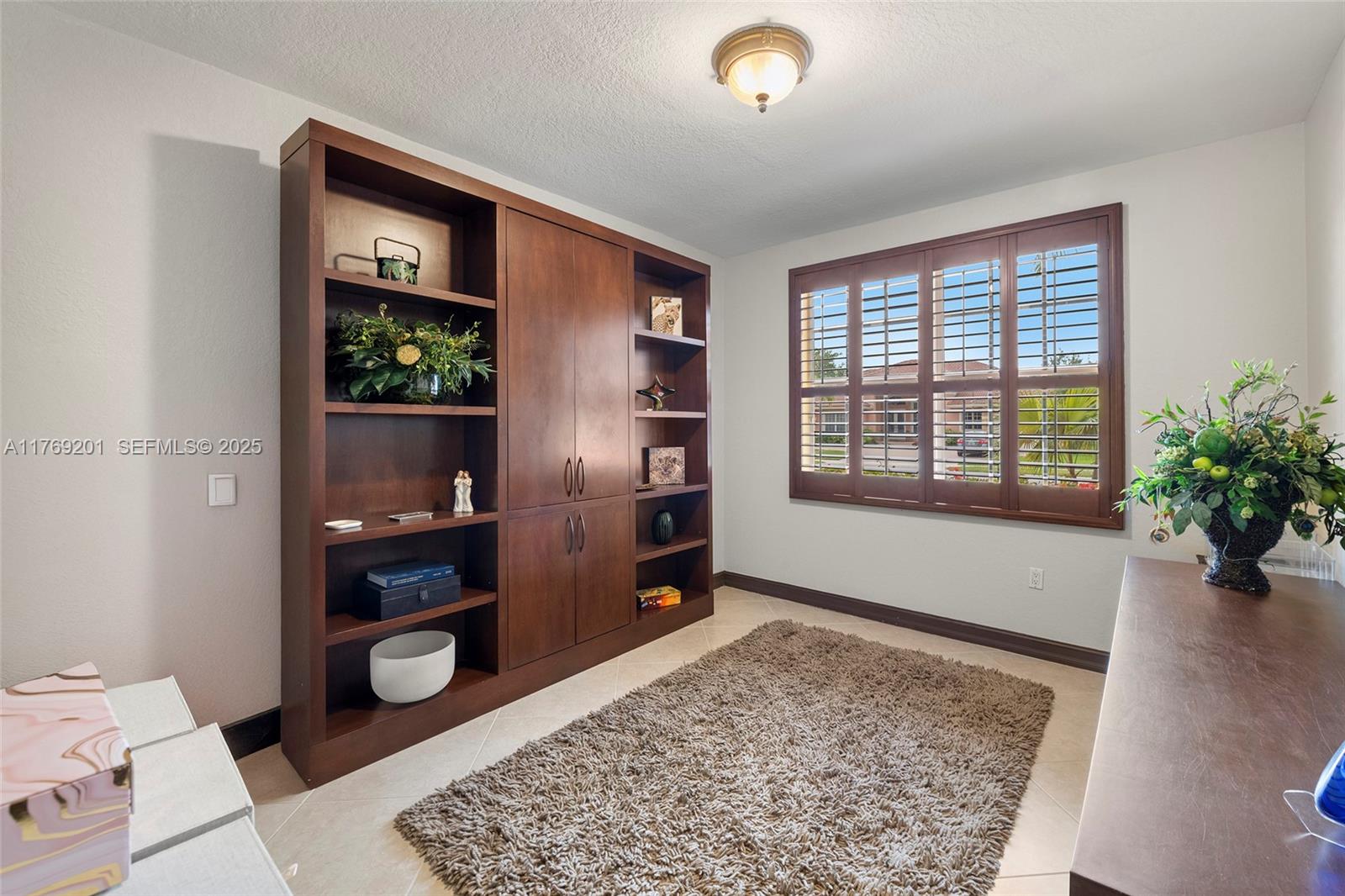 15045 Southwest 37th Street Davie, FL 33331 - Photo 27 of 57 a living room with furniture and a rug