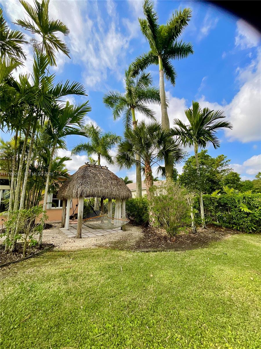 15045 Southwest 37th Street Davie, FL 33331 - Photo 43 of 57 a house view with a garden space