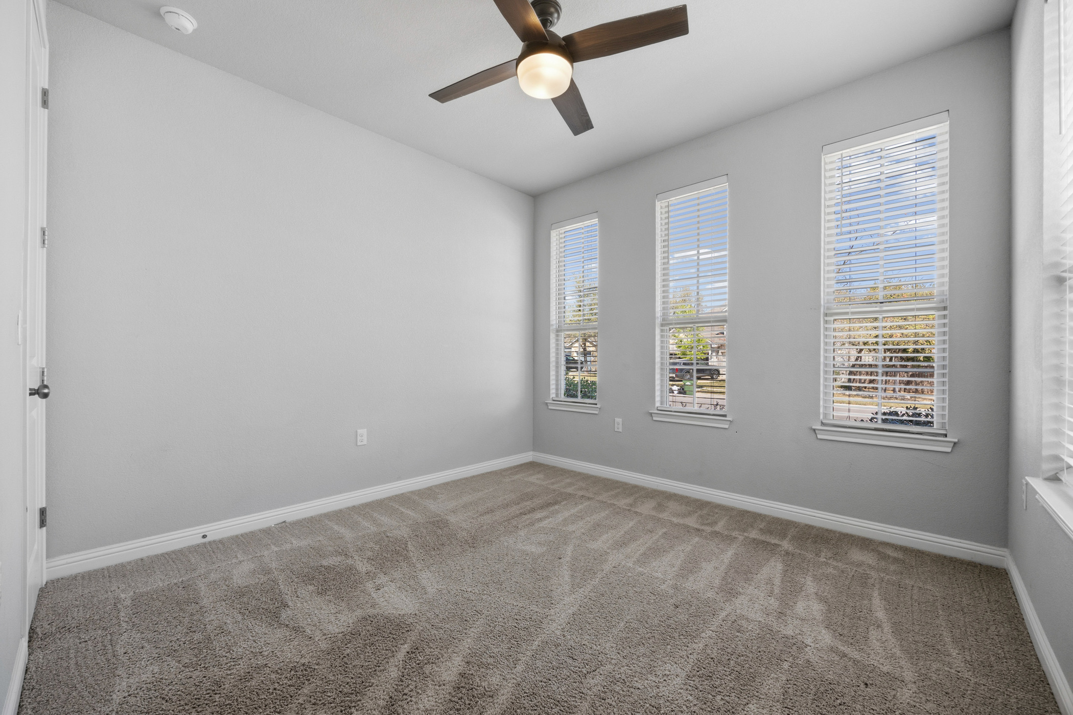 2209 Littleleaf Lane Leander, TX 78641 - Photo 11 of 27 Unfurnished room with light colored carpet and a ceiling fan